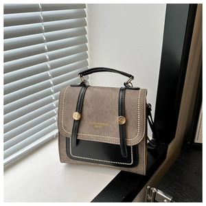 Detail of vintage square handbag with gold beaded trim and textured brown leather