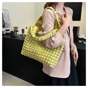 Close-up of cloud bubble textured tote bag with large capacity shown in a café setting