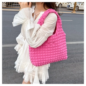Close-up of hot pink bubble fabric texture on a stylish puffy shoulder bag for women