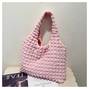 Detailed view of pink popcorn texture fabric on this stylish large capacity hobo bag