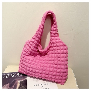 Close-up of rose pink popcorn texture and soft elastic fabric of the large tote bag