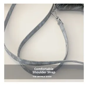 Detail of the gray marble textured shoulder strap with silver metal lobster clasp