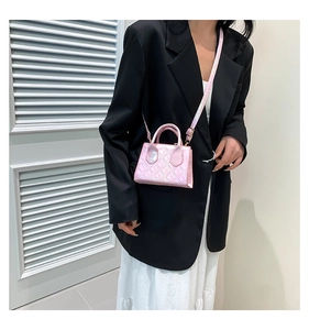 Pink quilted mini bag with pearl finish and adjustable strap shown on model style