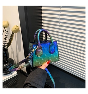 Detailed macro view of an iridescent mini bag with quilted pattern and gold hardware hooks