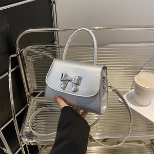Silver metallic crossbody handbag with fashion bow and curved top handle for women