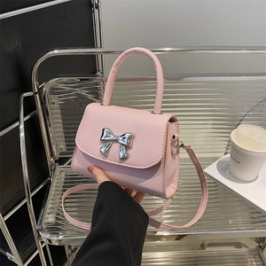 Chic pink leather handbag with a silver bow clasp for women's crossbody and shoulder use