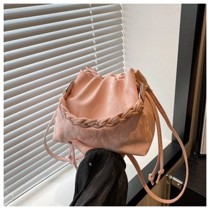 Detail of pink marble-pattern bucket bag with braided handle and drawstring closure