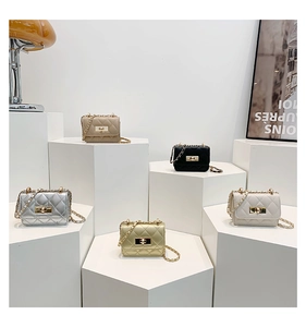 Mini quilted crossbody bags with chain straps in five colors on geometric pedestals