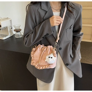 Pink drawstring bucket bag with pleated texture and cute white monster plush pendant