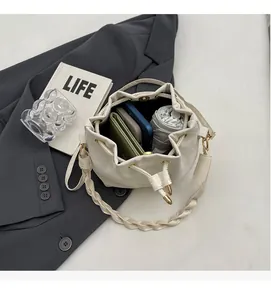 Overhead view showing large capacity of white drawstring bucket bag with daily essentials