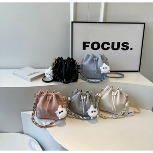 Detail of drawstring bucket bags in five colors with cute cloud pendants on steps