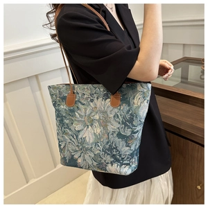Detail of vintage floral jacquard tote bag with premium brown leather shoulder straps