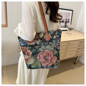 Detailed back view of a large embroidered floral tote bag with brown leather straps