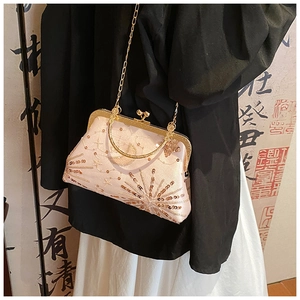 Detail of vintage beige embroidery bag with golden sequins and moon star patterns