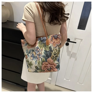 Detailed view of the vintage oil painting floral tapestry tote bag with brown straps