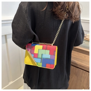 Detailed back view of a colorful geometric patchwork crossbody bag with gold chain strap