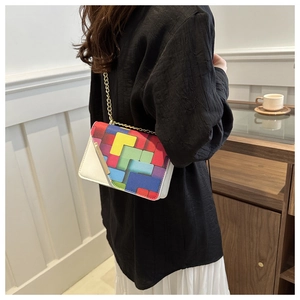 Crossbody small square bag with geometric prints and gold chain strap on model
