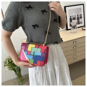 Fashionable crossbody bag with colorful geometric patchwork and elegant gold chain strap