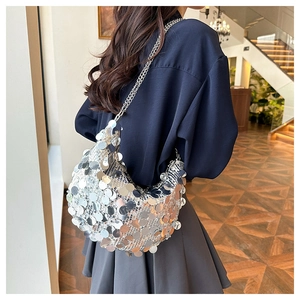 Silver sequin shoulder bag with metallic chain strap shown on model in party style