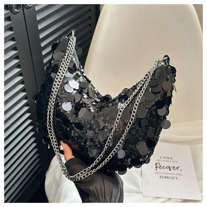 Detail of black sequin crescent shoulder bag with double silver chain straps