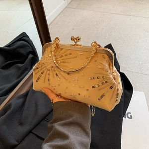 Elegant champagne gold sequin clutch bag with star patterns and metal top handle