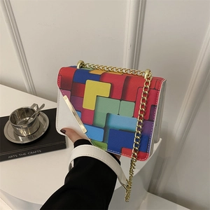 Chic color-block crossbody bag with gold chain strap and colorful geometric pattern