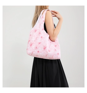 Sac fourre-tout rose à imprimé fleuri porté par un mannequin montrant sa capacité