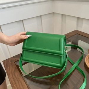 Minimalist green crossbody rectangular bag with elegant rectangular embossed lid