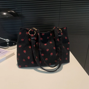 Chic black corduroy tote bag with red strawberry pattern and golden ring handles