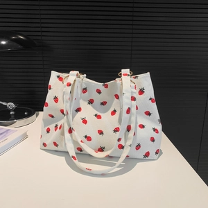 White corduroy tote bag with red strawberry print and gold metal rings for women
