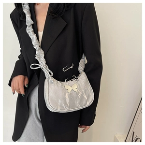 Détail du sac à bandoulière argenté plissé avec fermoir papillon et anse froncée souple
