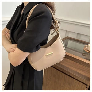 Detail view of the elegant beige hobo bag with a knotted strap and gold buckle