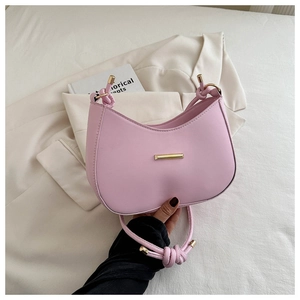Detailed shot of pink hobo bag with unique knotted strap and gold metallic accents