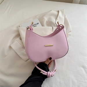 Pink minimalist semi-circle shoulder bag with knotted strap and gold metal hardware detail