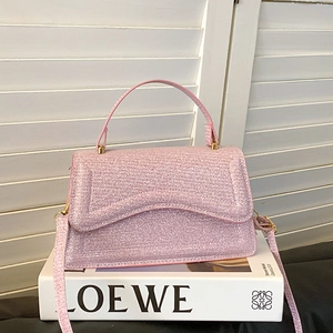 Sparkly light pink sequin handbag with gold hardware and top handle for elegant women