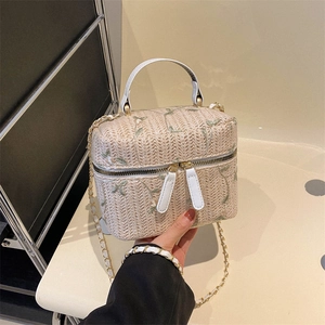 Beige straw bucket bag with floral embroidery and gold chain strap for women