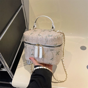 Handheld vintage straw bucket bag with floral embroidery and white leather handle