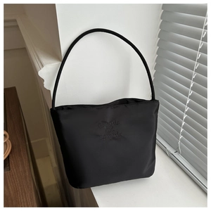 Close-up of black nylon handbag with onwards and upwards letter embroidery detail