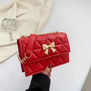 Quilted red square crossbody bag with gold bow decoration and chain strap for women