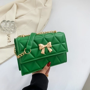 Green quilted chain bag with gold bow buckle and shoulder strap for elegant women