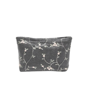 Dark grey woven clutch with pink floral embroidery and flat trapezoidal structure