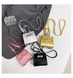 Detailed view of mini metallic cross-body bags in silver, gold, pink and black styles