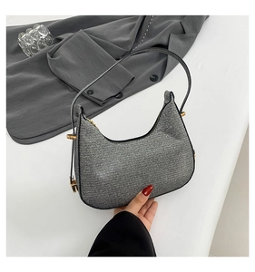 Close-up of silver sequin hobo bag with shimmering texture and golden hardware
