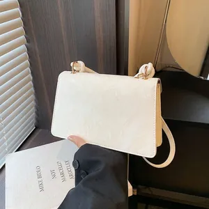 Chic white marble textured flap bag with unique knotted handle and shoulder strap