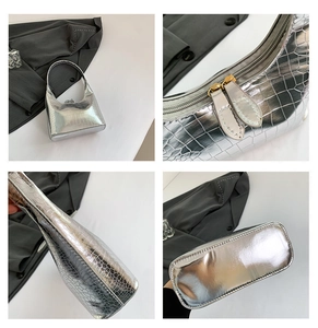 Détails d'un sac à main argenté à motif crocodile avec fermeture éclair dorée chic