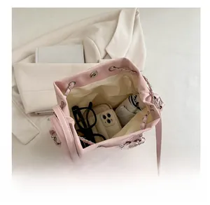 Pink bucket bag interior showing capacity with drawstring and silver chain strap details