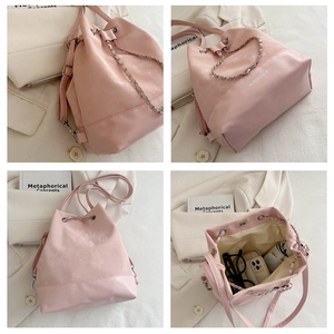 Detail view of pink bucket bag with chain drawstring and spacious internal structure
