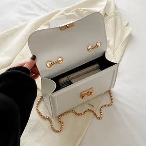 Interior view of white chain bag showing capacity for long wallet and essentials