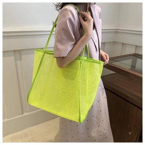 Detail of neon green mesh tote bag showing breathable material and large capacity texture