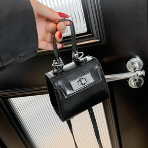 Miniature black textured leather micro bag with metallic swivel lock and shoulder strap